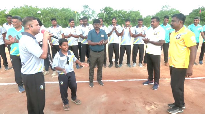 Karur District Superintendent of Police SP Prabhakar holding a cricket bat and playing a shot to inaugurate the police cricket tournament at Karur Armed Reserve ground in June 2026.
