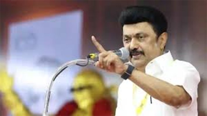 DMK President MK Stalin addressing a massive political gathering from a stage in Chennai holding a microphone in June 2026