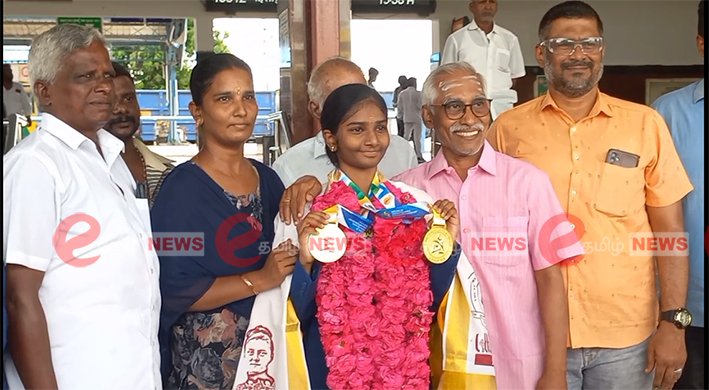 A talented female student from Karur holding two gold medals proudly at a felicitation event after winning the International Yoga Championship on June 12 2026.